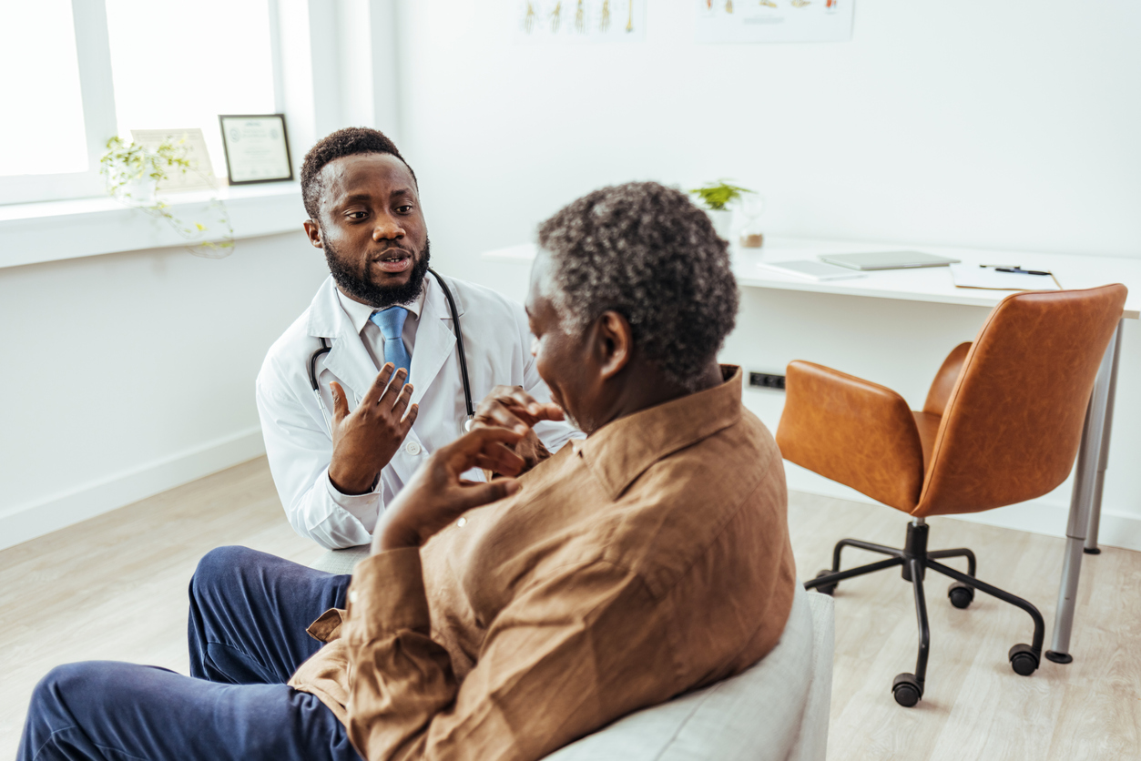 A clinician speaking with a patient about cancer care